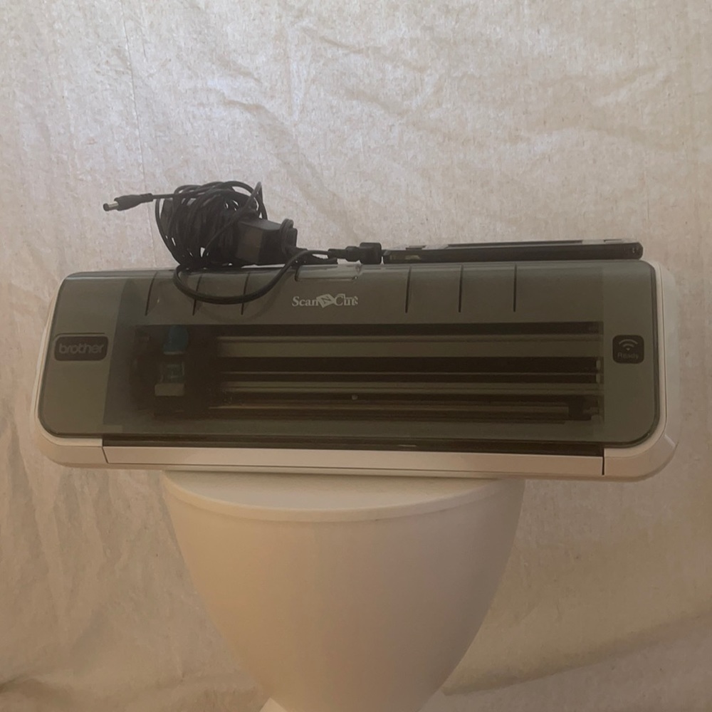 Brand new scan n cut machine with cord and brand new dye cutting sheet.